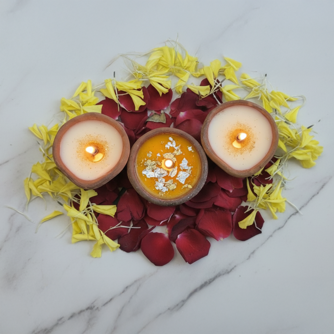 Diya candle with traditional clay lamps and floral decoration