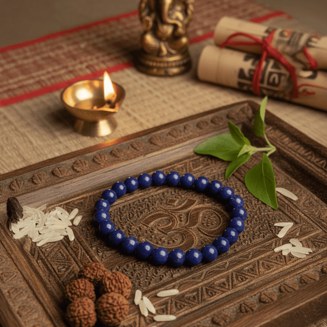 Natural Lazurite crystal bracelet with deep blue beads placed on a spiritual wooden tray for meditation and energy healing
